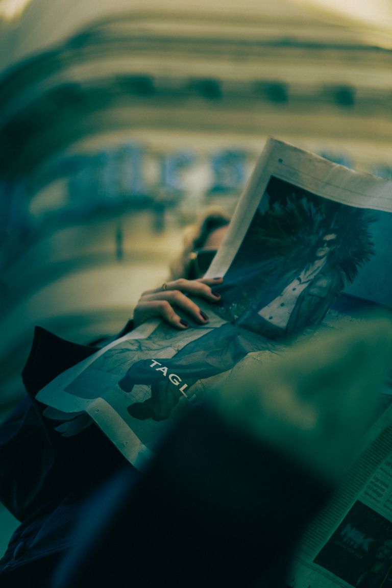 Editorial portrait holding a newspaper